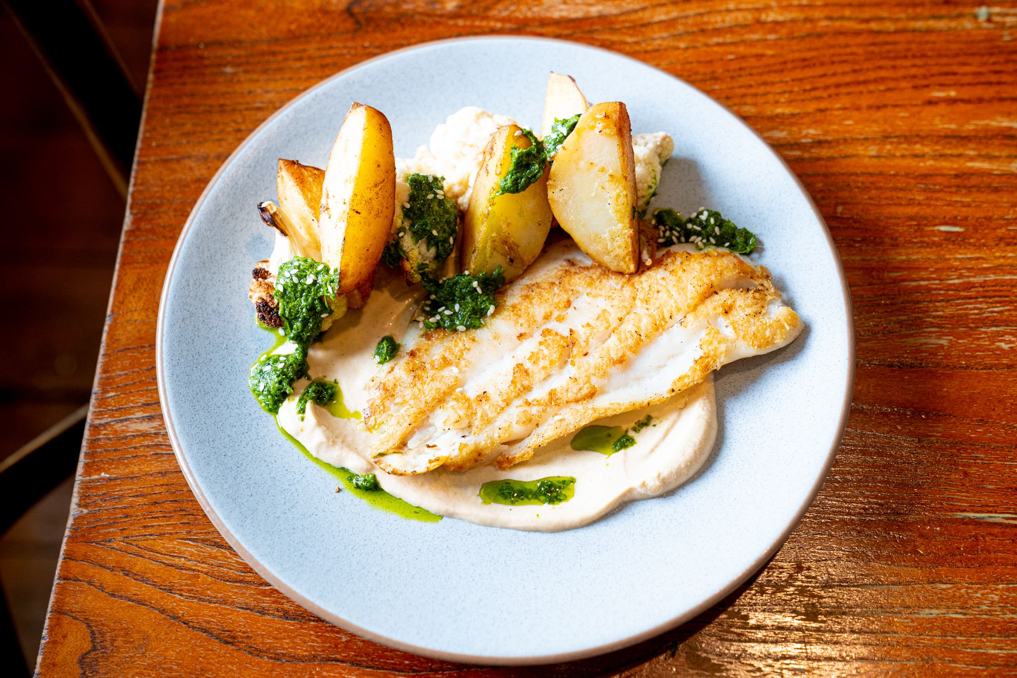 Snapper w tahini yoghurt sauce and zhug, roasted cauliflower & potatoes